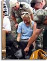 Rescuers gather around bear cub as Elina Garrison holds her